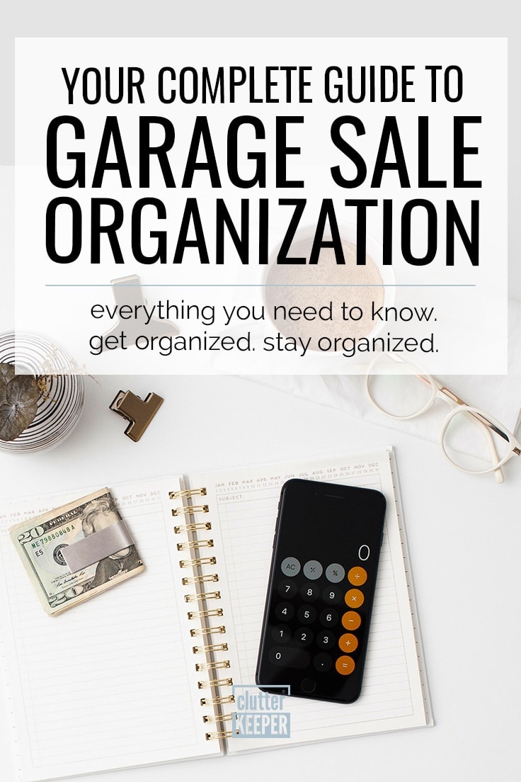 Your complete guide to garage sale organization. Everything you need to know. Get organized. Stay organized. A calendar sitting open on a desk with a calculator and a money clip with a $20 bill sitting on top of it to help you plan a yard sale. Next to it is a cup of coffee, a pair of glasses and two binder clips.