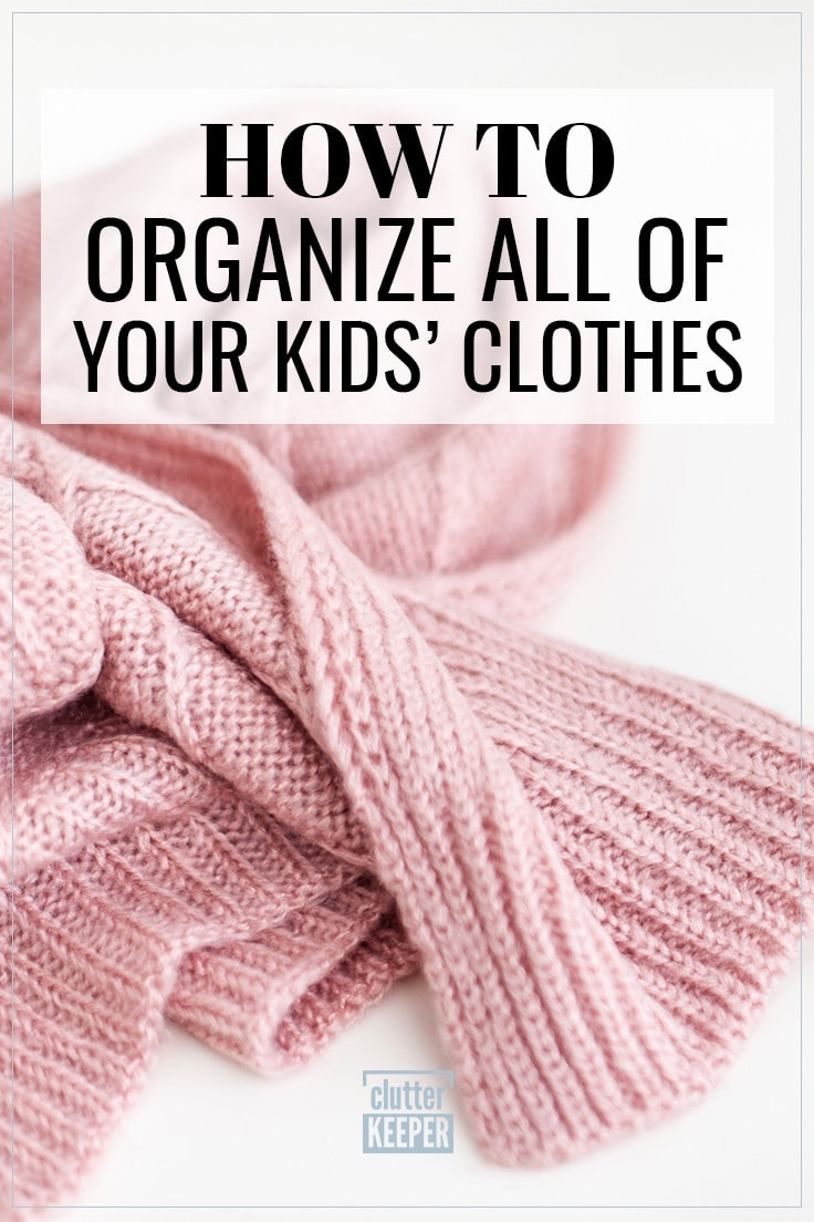 Pale pink knit sweater, curled up in a ball on a plain white background to illustrate the need for organizing kids' clothes.