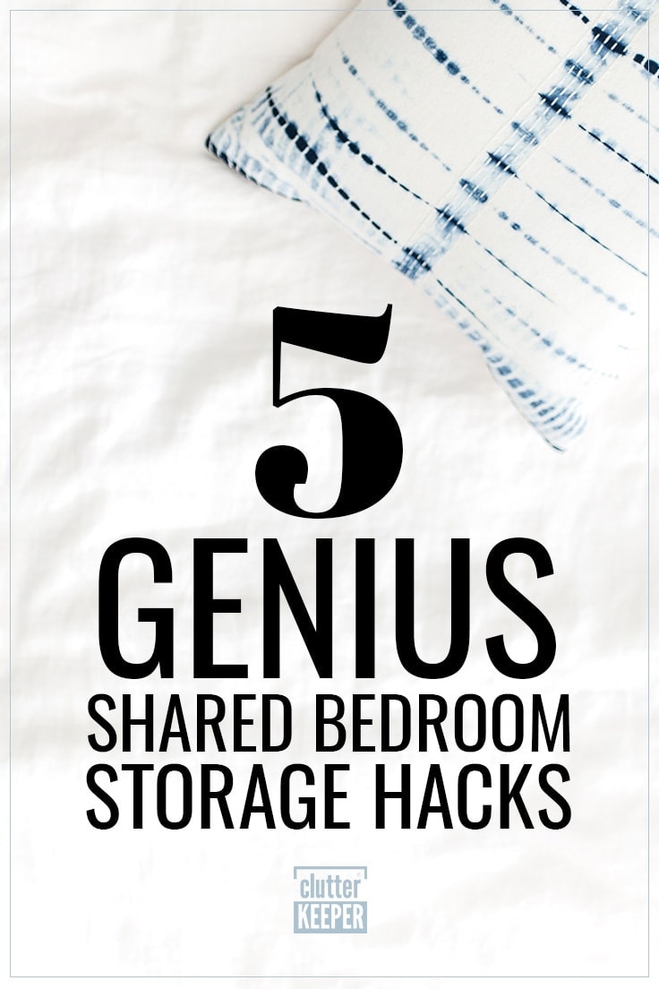 5 Genius Shared Bedroom Storage Hacks, a rumpled white comforter on an unmade bed along with a blue and white tie-dyed throw pillow.