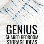 Genius Shared Bedroom Storage Ideas, a rumpled white comforter on an unmade bed along with a blue and white tie-dyed throw pillow.