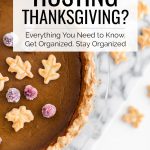 Hosting Thanksgiving? Everything You Need to Know. Get Organized. Stay Organized. -- pumpkin pie with sugared cranberries and small leaves made of pie crust on top