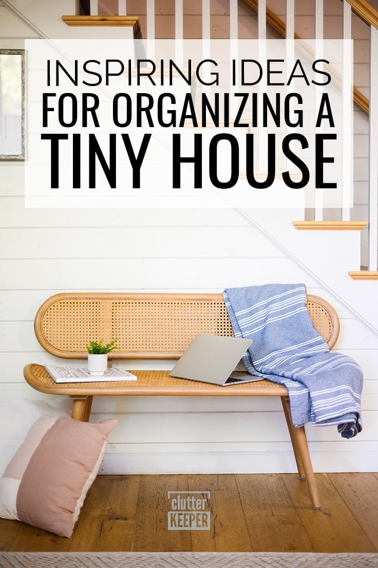 Inspiring Ideas for Organizing a Tiny House, A modern style wicker love seat chair in front of plank wall with a staircase. On the wicker love seat is a throw blanket, a laptop computer, a small plant and a to do list