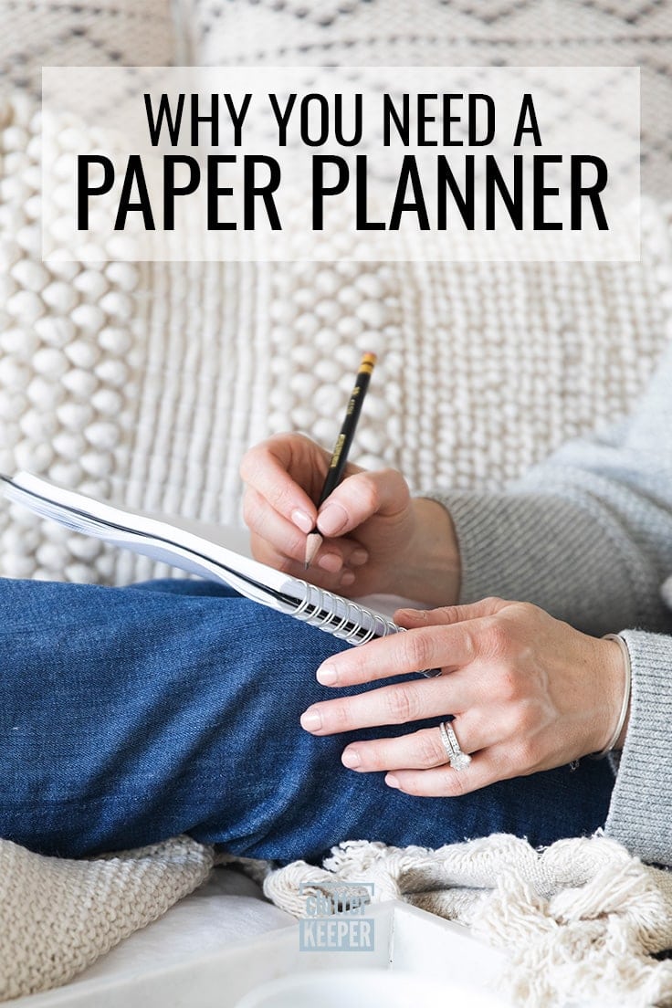 Why you need a paper planner, a side view of a woman wearing jeans writing in a planner