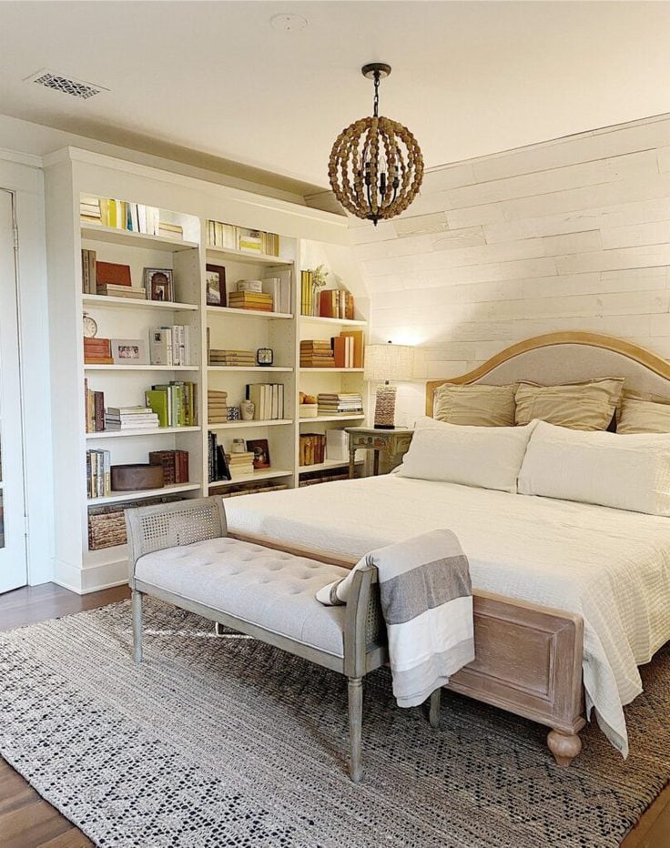 A bookshelf full of books in a bedroom 